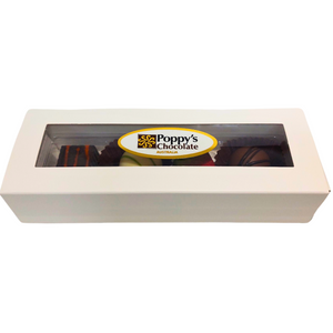 A white rectangular box with a transparent lid presents an assortment of truffles inside. The lid is adorned with a label that reads "Poppy's Chocolate" along with a decorative design, making it the perfect premium gift box for the Gift Box 4 gourmet chocolates from Poppy's Chocolate Australia.