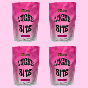 Four identical stand-up pouches of Lucky Bite arranged in a 2x2 grid on a solid pink background.