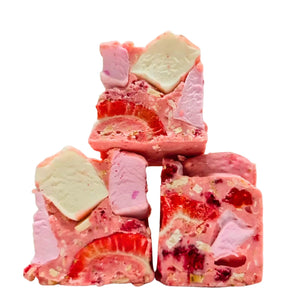 A stack of square-shaped Pink Blossom Rocky Road with visible ingredients such as marshmallows, freeze dried raspberries, and nuts.