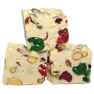 Three stacked pieces of Poppy’s White Christmas with white chocolate, rice puffs, fruit and nuts