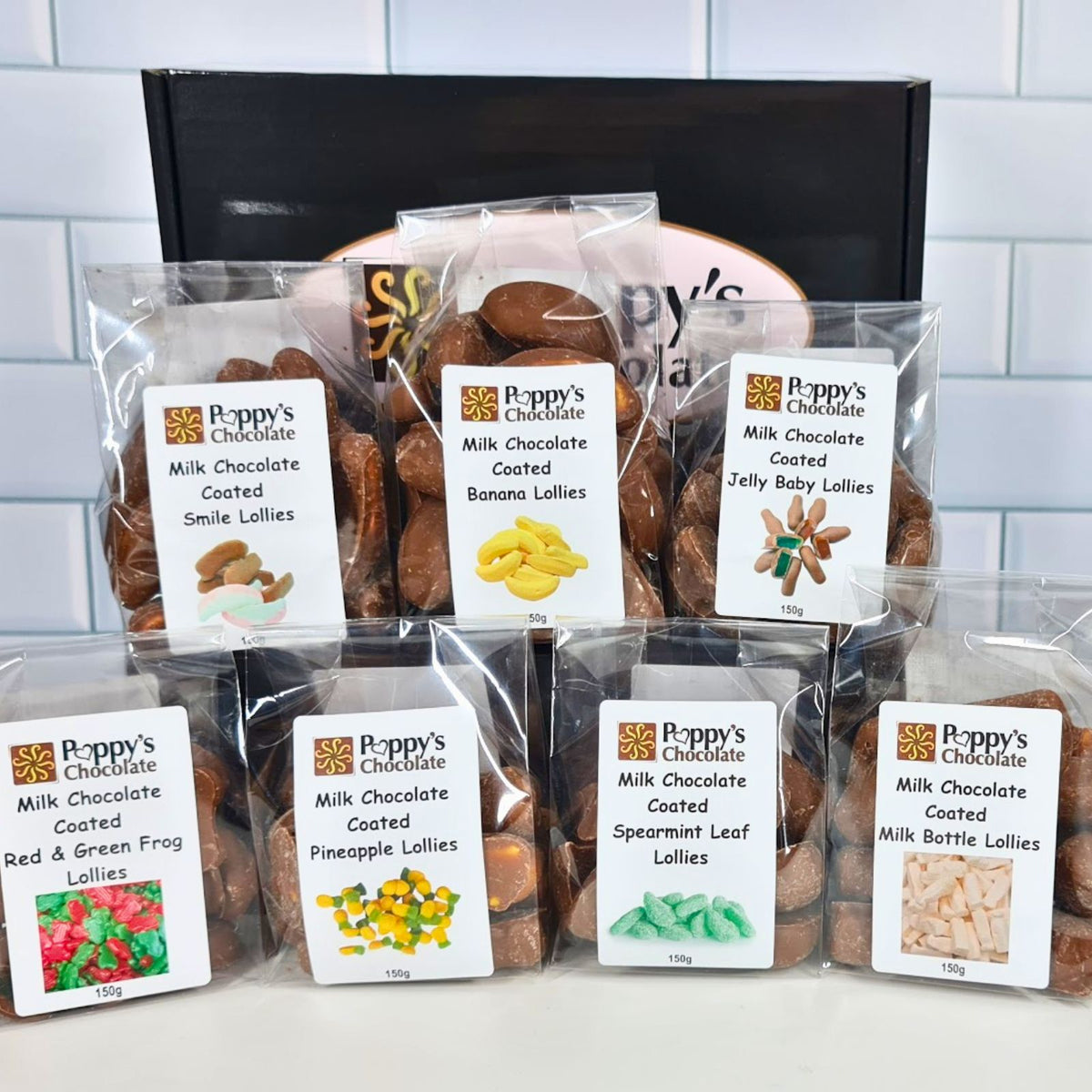 Poppy's Chocolate Coated Lollies. Classic Lollies coated in Milk Chocolate in Poppy's black hamper box.