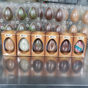 Easter eggs in packaging on a reflective surface