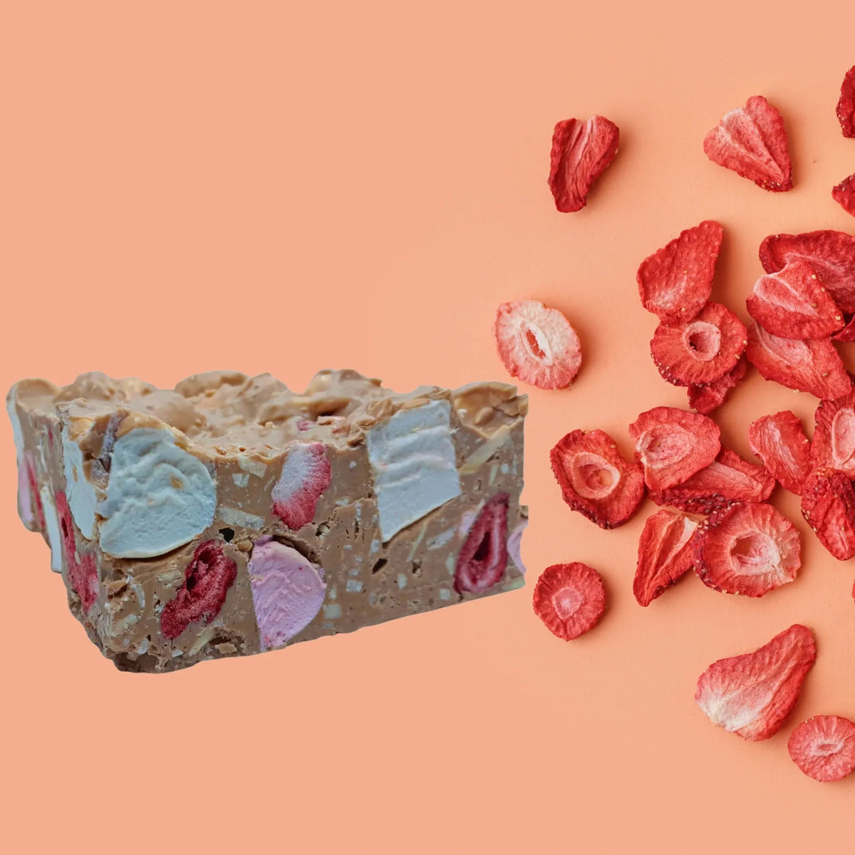Strawberry and Almond Rocky Road in Caramel chocolate next to Freeze dried strawberries
