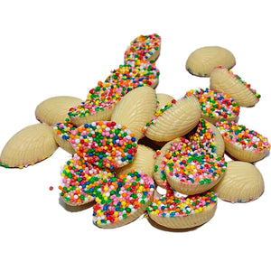 A pile of Mini Half Easter Eggs  half-covered with colourful sprinkles.  