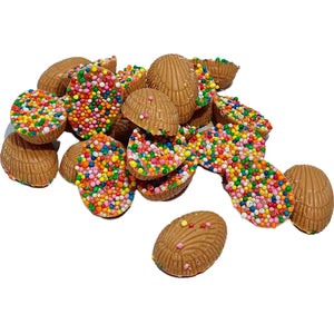 A pile of Mini Half Easter Eggs in Caramel Chocolate half-covered with colourful sprinkles. 