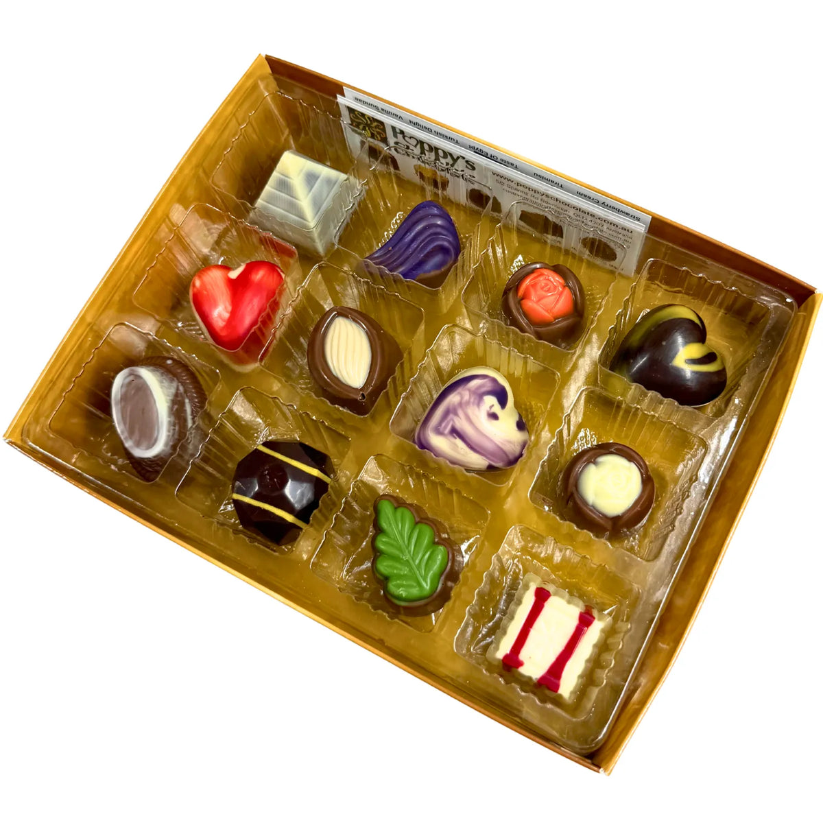 Experience the delight of a Gift Box featuring 12 gourmet chocolates, beautifully crafted into heart shapes, swirls, and marbled patterns. This elegant collection from Poppy's Chocolate is presented in a premium gift box and weighs 130 grams, making it an irresistible treat for any occasion.