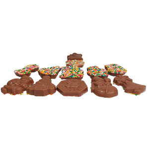 Side view of Christmas milk chocolate bites showing their thickness and colourful sprinkles.