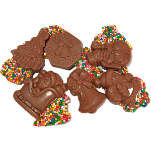 Christmas milk chocolate bites arranged to show festive designs and colourful sprinkle-covered backs.