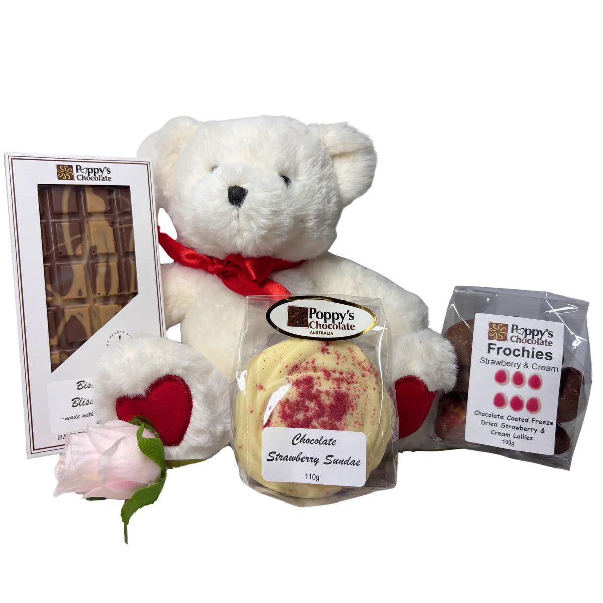 A curated Just Because hamper featuring assorted chocolates and sweets, paired with a short stem rose and a small plush love bear.