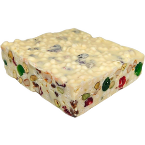 Angled view of Poppy’s White Christmas block showing its square shape, thickness and fruit and nut pieces.