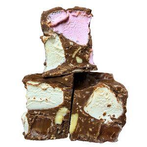 Three stacked pieces of chocolate ice cream bark, showing layers of pink and white vanilla ice cream mixed with melted dark and milk chocolate, set against a plain white background.