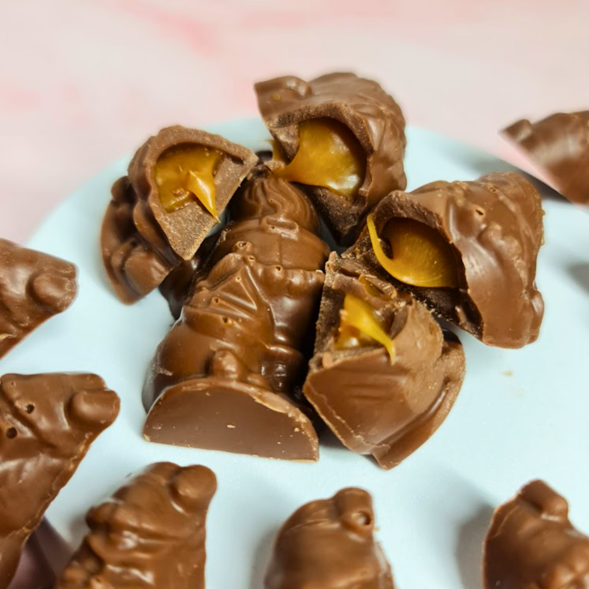 Milk chocolate Santas cut open to reveal golden salted caramel filling.