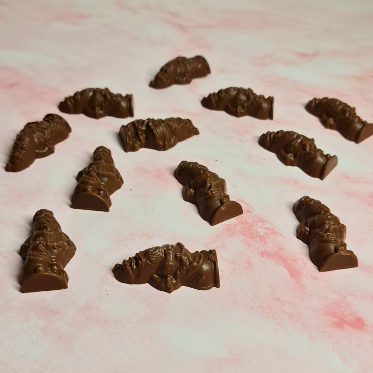 Twelve milk chocolate Santas with salted caramel filling displayed 