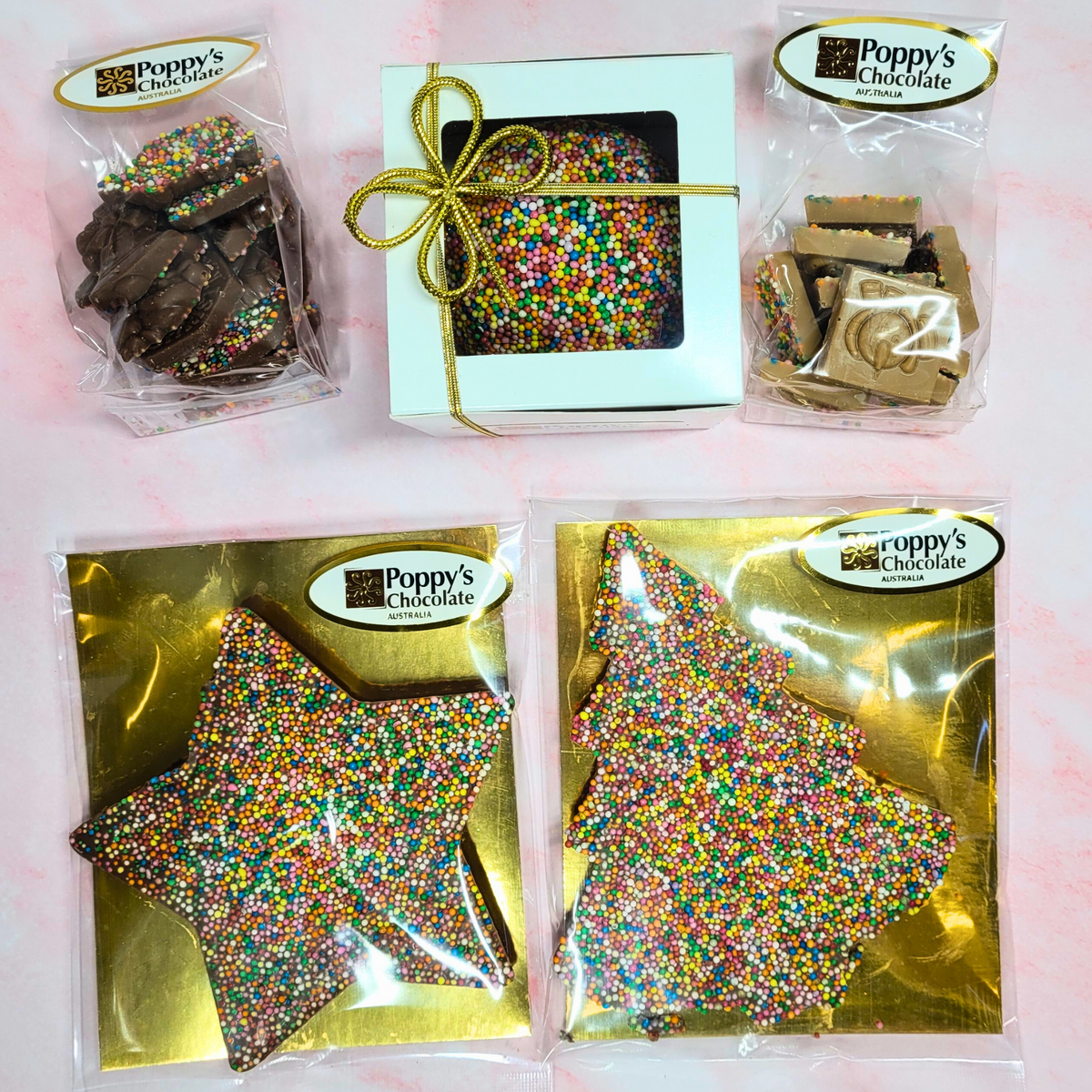 Overhead view of the Christmas sprinkle chocolate selection in Poppy’s Chocolate packaging.