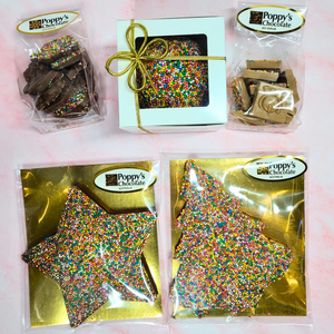 Overhead view of the Christmas sprinkle chocolate selection in Poppy’s Chocolate packaging.