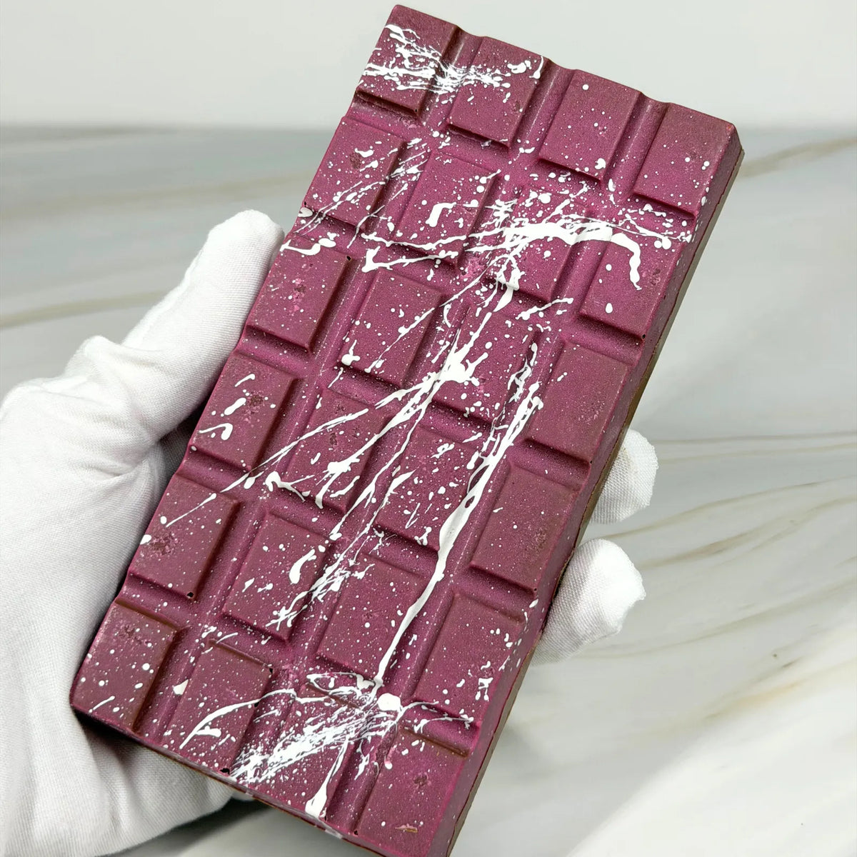 Poppy’s Chocolate Berry Butterscotch Crunch Bliss Block, showing a thick chocolate block filled with creamy butterscotch and berry pieces.