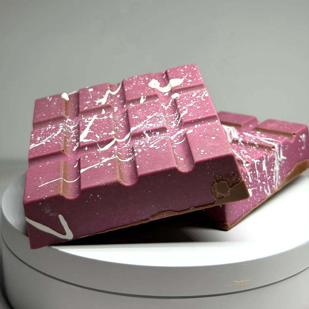 Poppy’s Chocolate Berry Butterscotch Crunch Bliss Block, showing a thick chocolate block filled with creamy butterscotch and berry pieces.