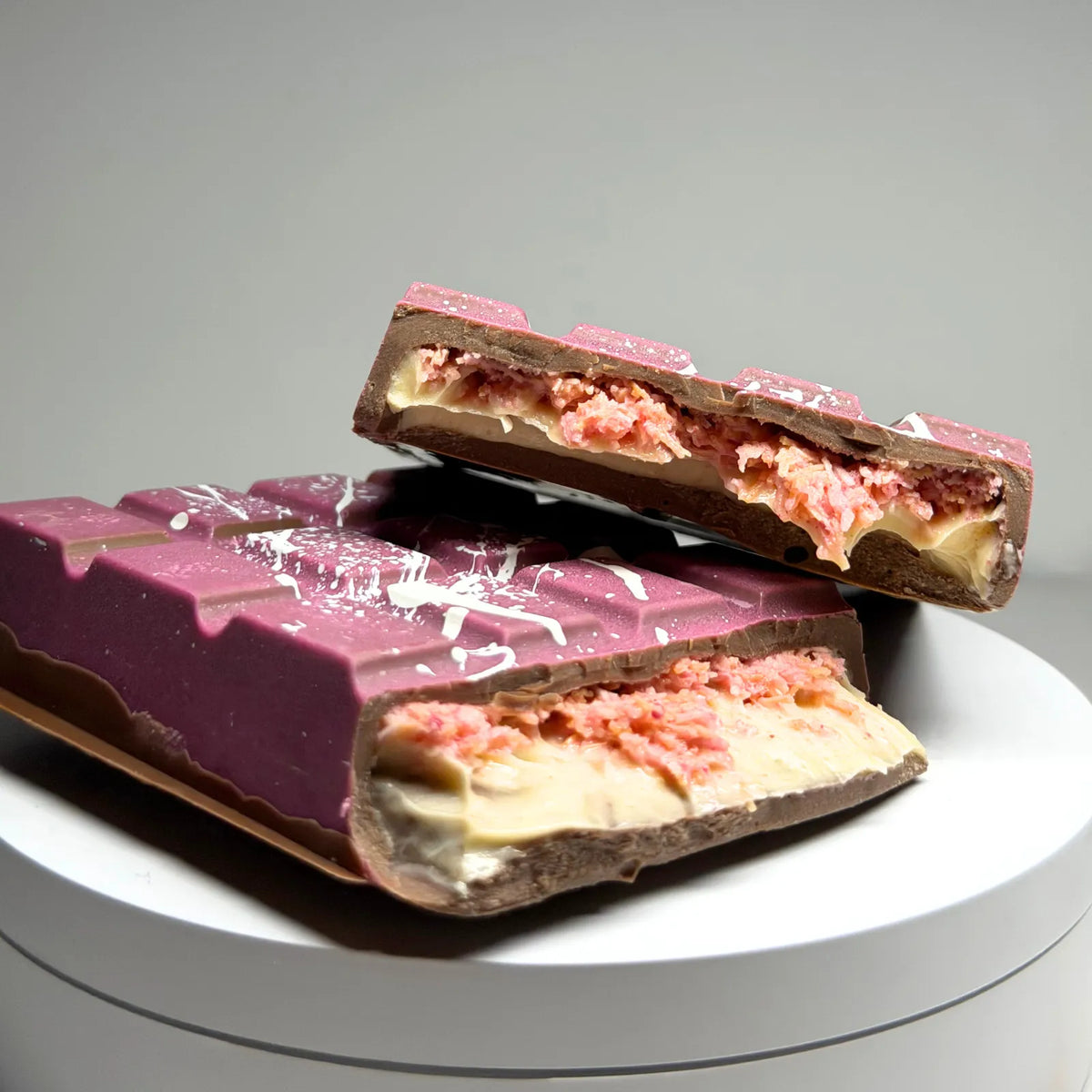 Poppy’s Chocolate Berry Butterscotch Crunch Bliss Block, showing a thick chocolate block filled with creamy butterscotch and berry pieces.