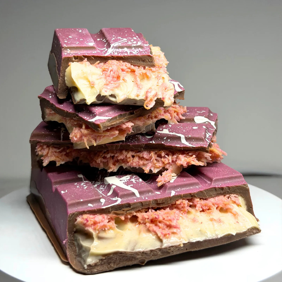 Poppy’s Chocolate Berry Butterscotch Crunch Bliss Block, showing a thick chocolate block filled with creamy butterscotch and berry pieces.