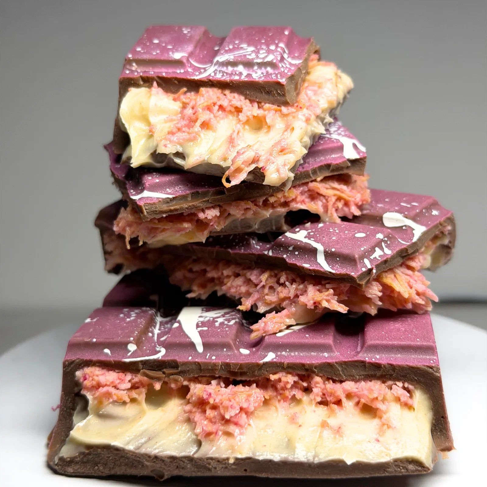 Poppy’s Chocolate Berry Butterscotch Crunch Bliss Block, showing a thick chocolate block filled with creamy butterscotch and berry pieces.
