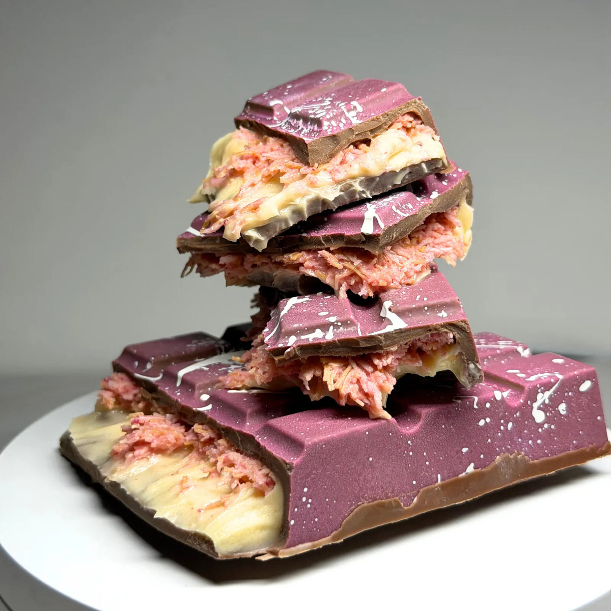 Poppy’s Chocolate Berry Butterscotch Crunch Bliss Block, showing a thick chocolate block filled with creamy butterscotch and berry pieces.