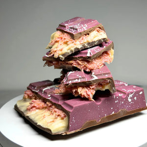 Poppy’s Chocolate Berry Butterscotch Crunch Bliss Block, showing a thick chocolate block filled with creamy butterscotch and berry pieces.