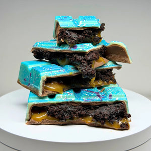 Handmade milk chocolate Salted Caramel Chocolate Brownie Bliss Block with a blue and violet chocolate finish, gluten-free mud cake and gooey salted caramel filling.