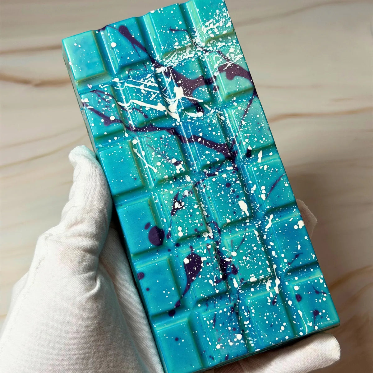 Handmade milk chocolate Salted Caramel Chocolate Brownie Bliss Block with a blue and violet chocolate finish, gluten-free mud cake and gooey salted caramel filling.
