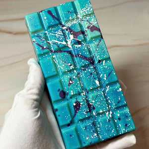 Handmade milk chocolate Salted Caramel Chocolate Brownie Bliss Block with a blue and violet chocolate finish, gluten-free mud cake and gooey salted caramel filling.
